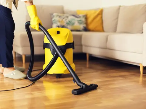 Vacuuming hardwood floors during a move-out cleaning
